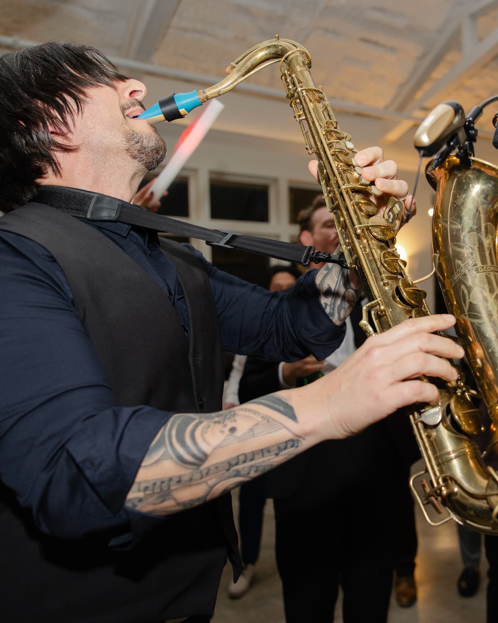 Greg Capozzi playing tenor sax in the middle of a wedding dance floor