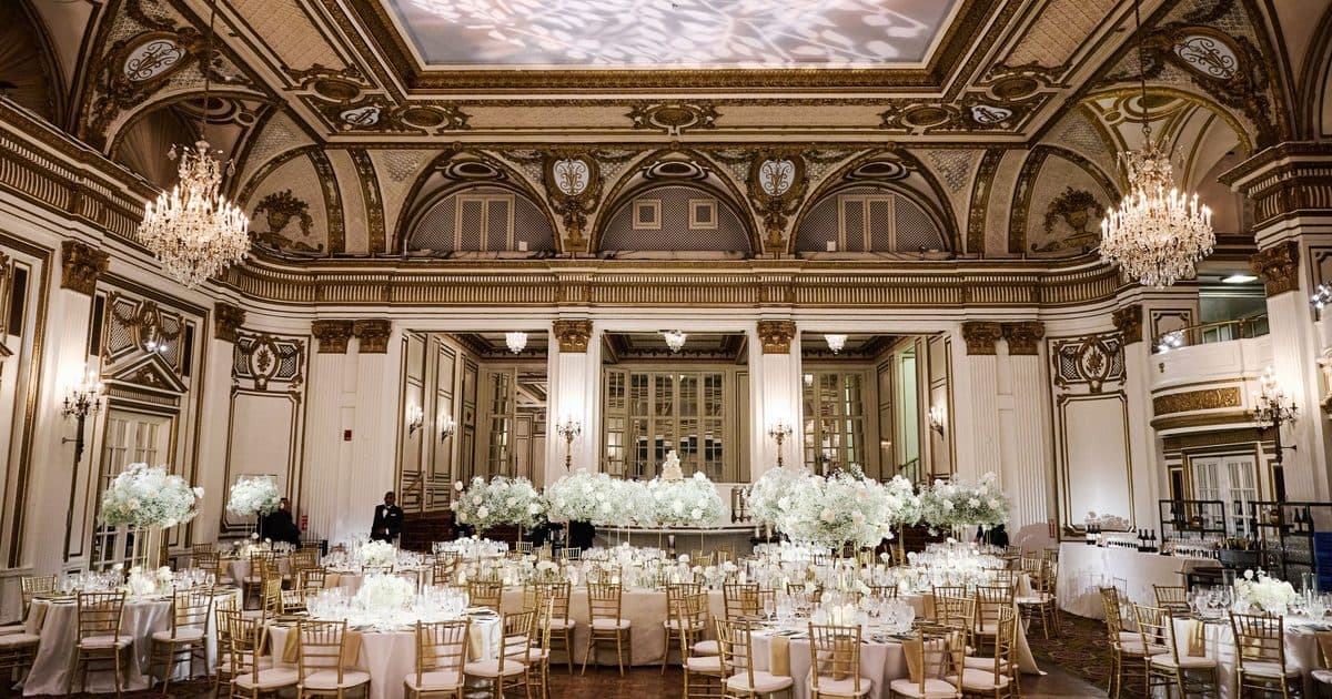 The Grand Ballroom at the Fairmont Copley Plaza set for a wedding dinner under crystal chandeliers