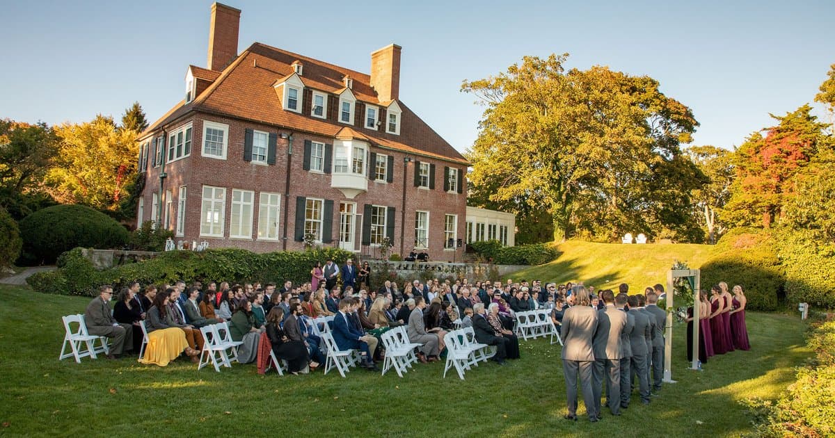 The Misselwood mansion behind a seated wedding ceremony on the lawn