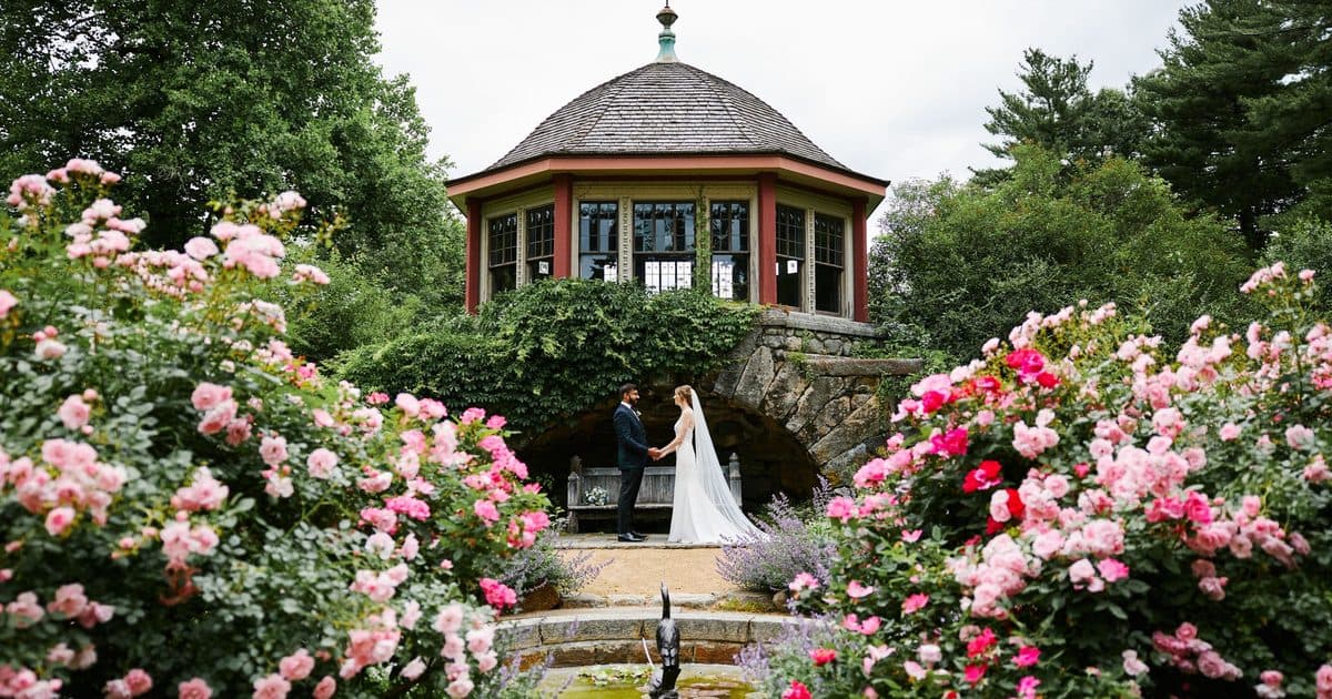 The historic tea house at Moraine Farm framed by pink and red roses