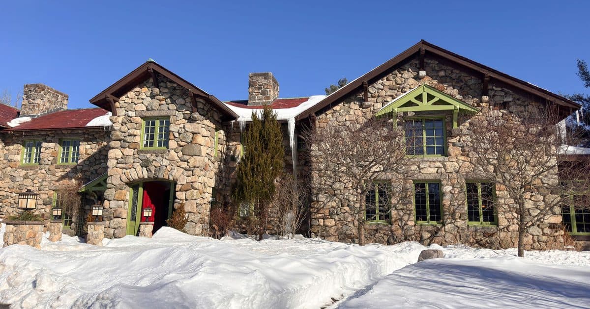 The fieldstone front of the Willowdale Estate mansion with its red door
