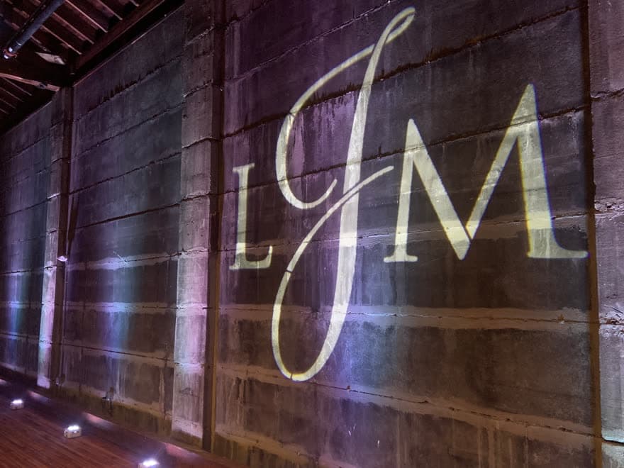 Custom wedding monogram projected on a stone wall