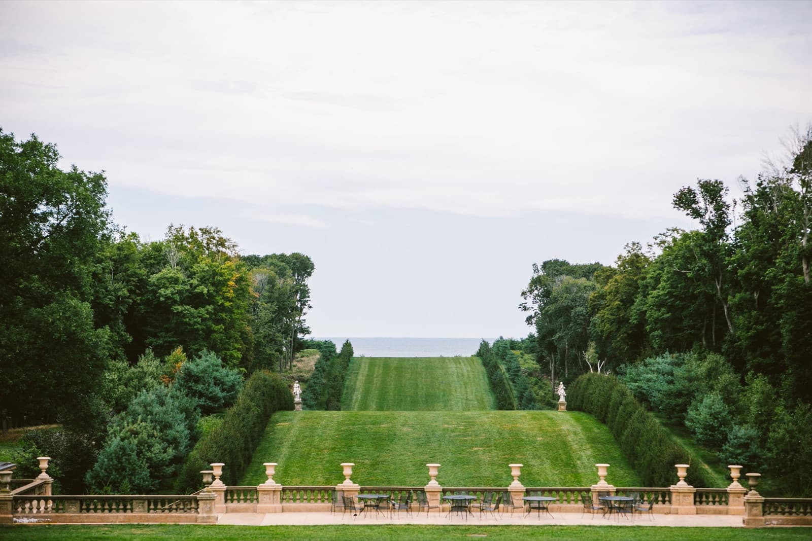 The Grand Allée at the Crane Estate, a long lawn between rows of evergreens running down to the ocean