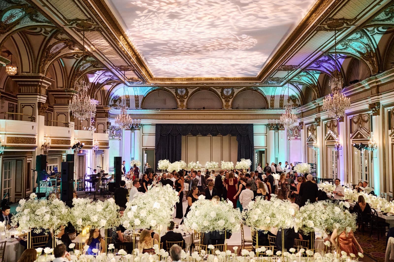 The Grand Ballroom at the Fairmont Copley Plaza with teal and purple uplighting on the walls