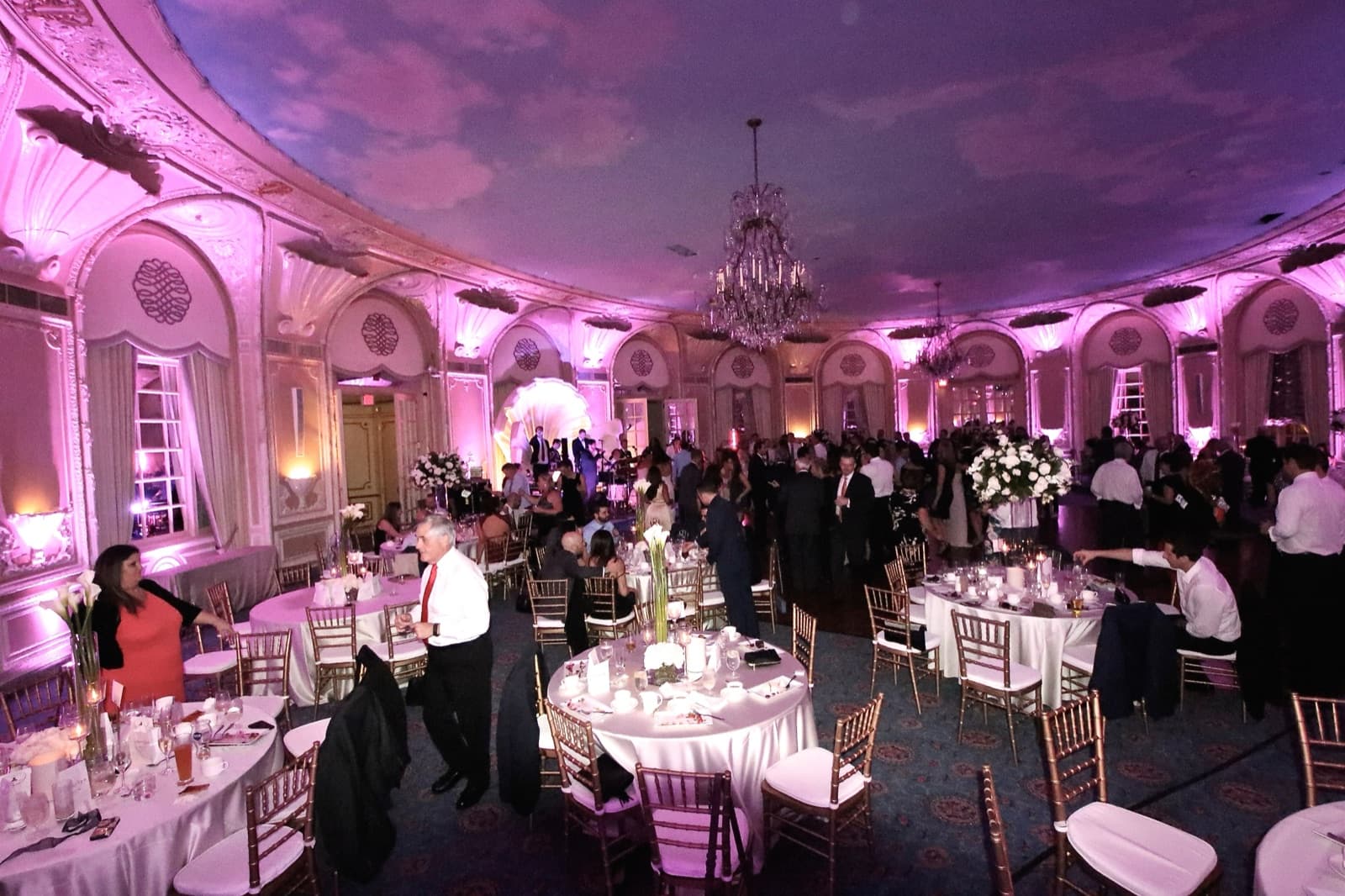The Oval Room at the Fairmont Copley Plaza full of guests under lavender uplighting