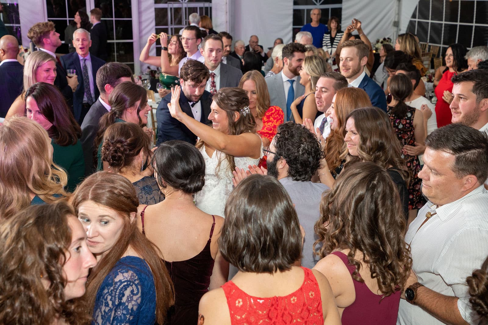 A packed dance floor in the Misselwood tent under colored light