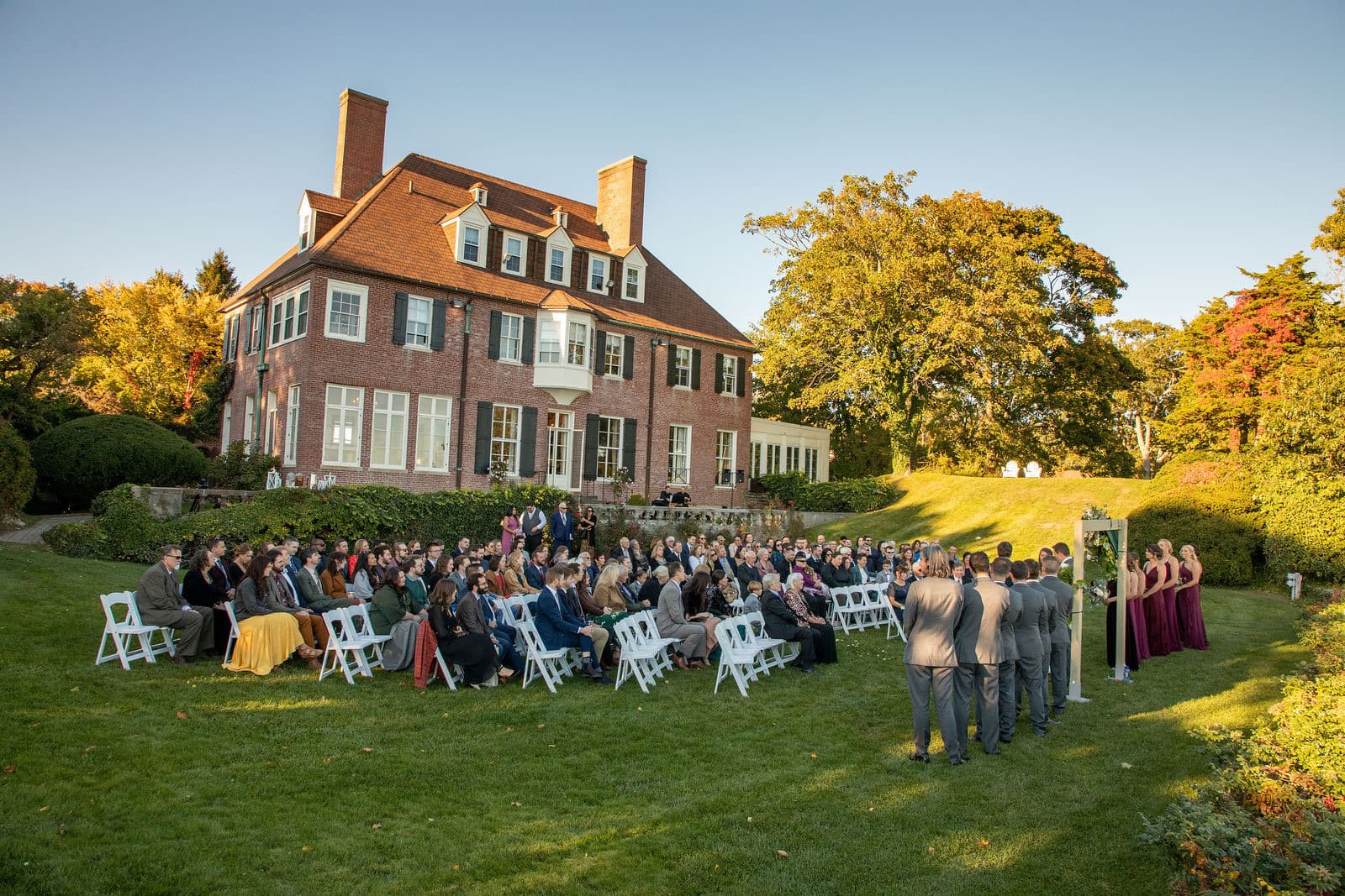 The Misselwood mansion behind a seated wedding ceremony on the lawn