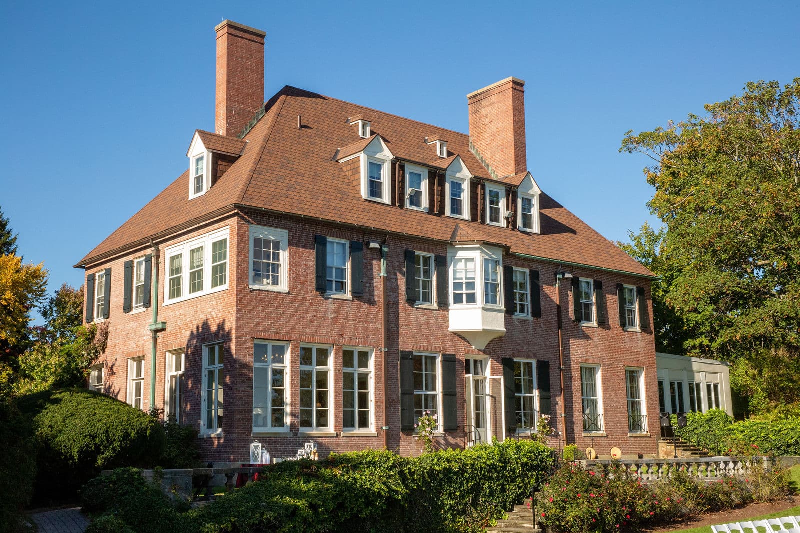 The brick front of the Misselwood mansion against a blue sky