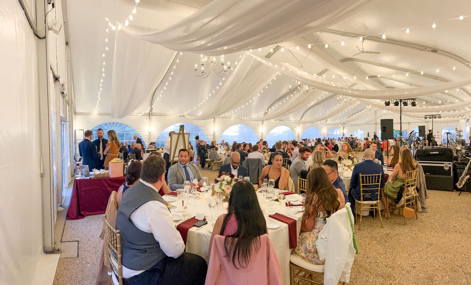 Guests seated for dinner under the white draping of the Misselwood tent