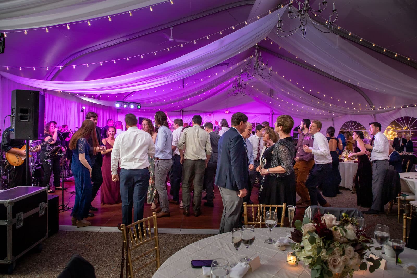 The Misselwood tent washed in purple uplighting with the dance floor and the stage