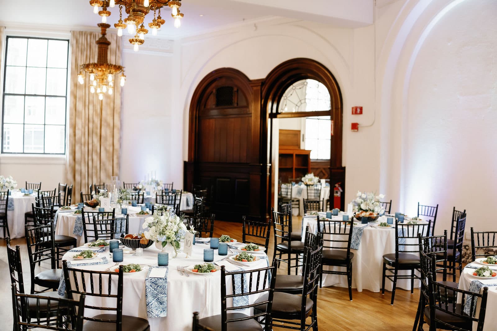 Dinner tables at The Tower with the wall behind them washed in uplighting