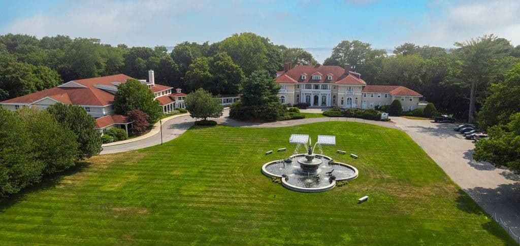 Aerial view of Tupper Manor, its lawn and the fountain, with the ocean beyond the trees
