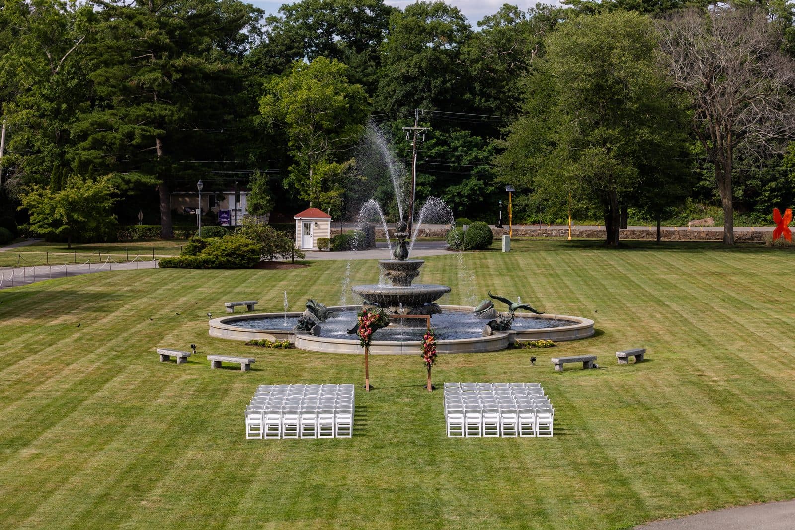 Ceremony chairs set on the Tupper Manor lawn in front of the fountain