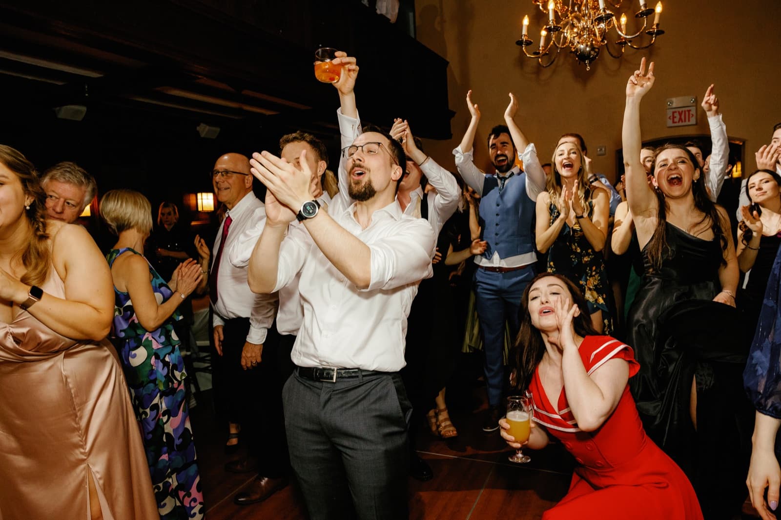 Guests with their hands in the air on a packed dance floor at Willowdale Estate