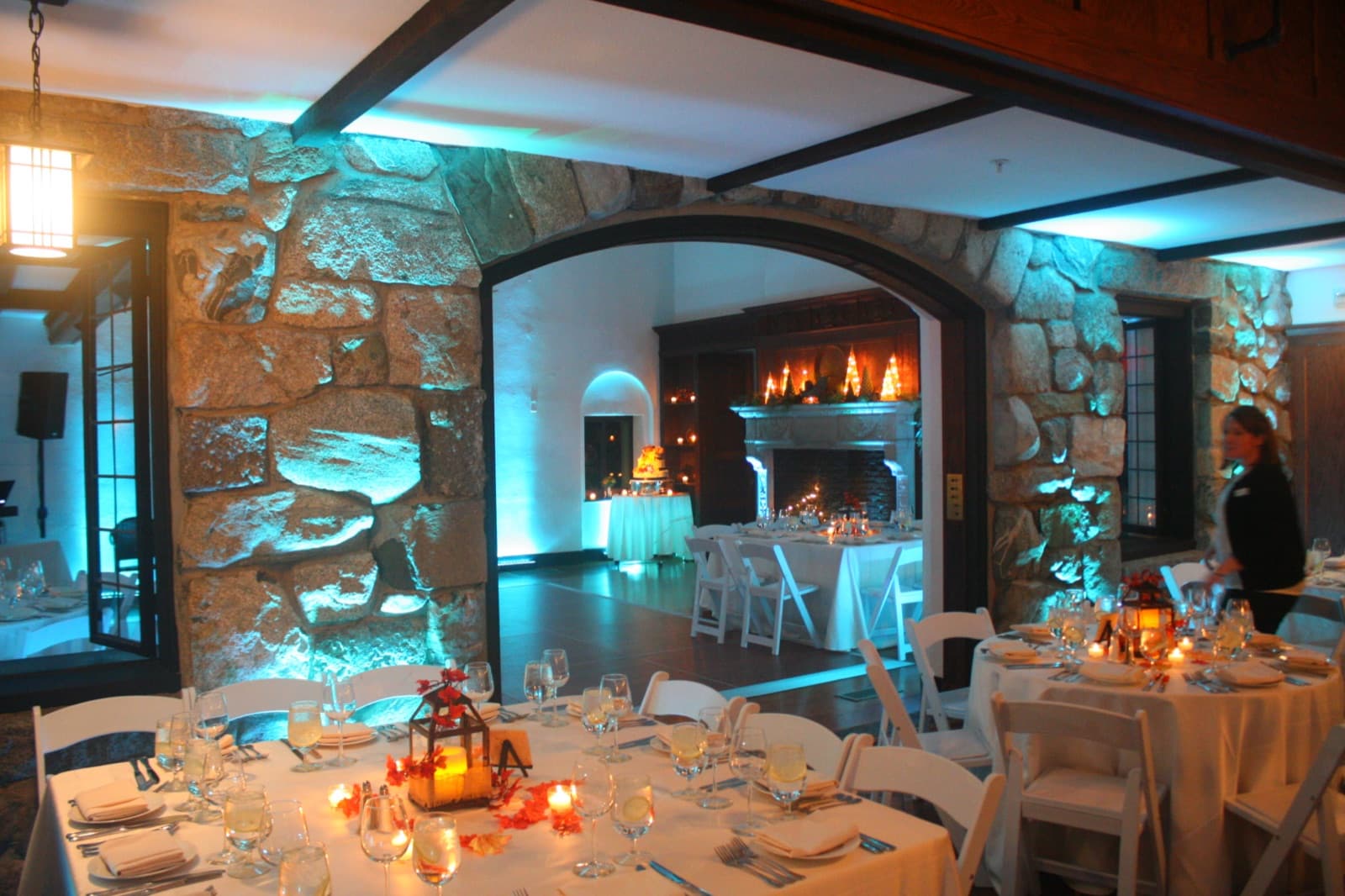 The same stone-walled room at Willowdale Estate in teal uplighting